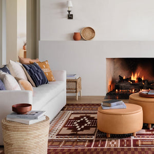 Embroidered pillow on couch, mustard