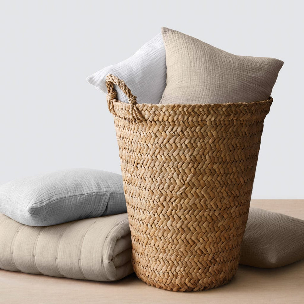 Throw pillows styled in and around storage basket
