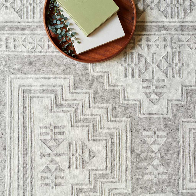 Wood tray sitting on flatweave rug, light-grey