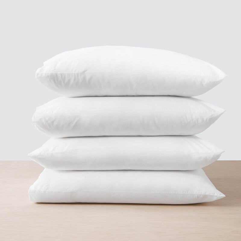 stack of four white linen pillowcases, white