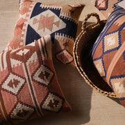Overhead of woven kilim pillows in navy and dusty pink, Navy